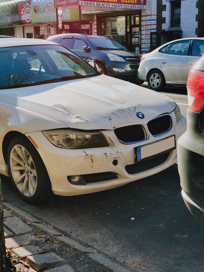 Damaged Front of A White Car